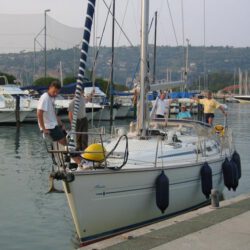 4 persons on boat lying in the port