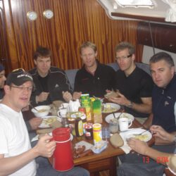 7 people have breakfast in the boat interior
