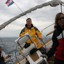 3 persons on boat lying in the curve